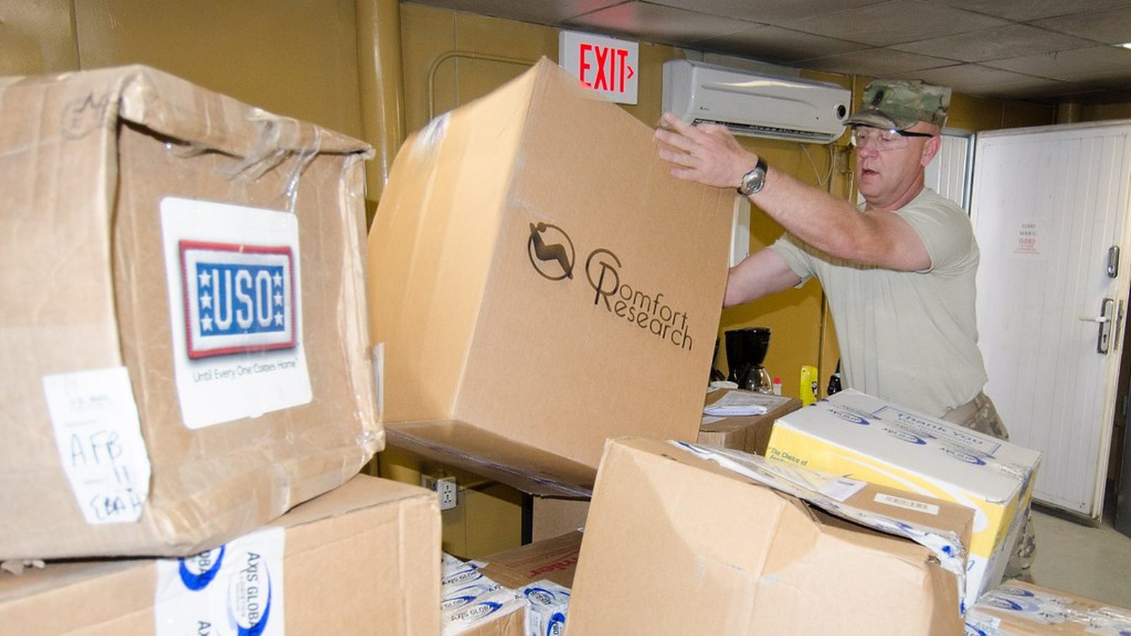 Stack of plain cardboard shipping boxes of different sizes on a neutral background